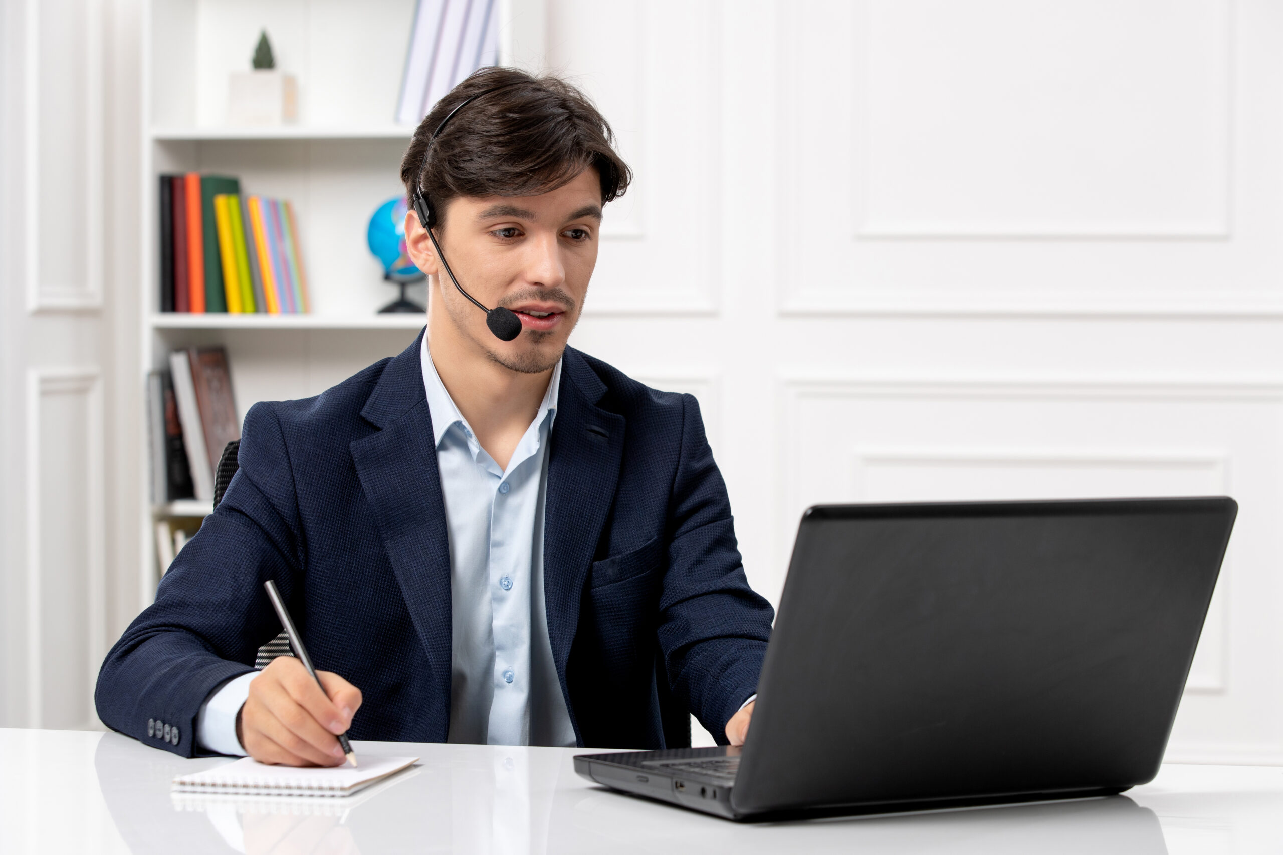 customer-service-handsome-guy-with-headset-laptop-suit-taking-down-notes