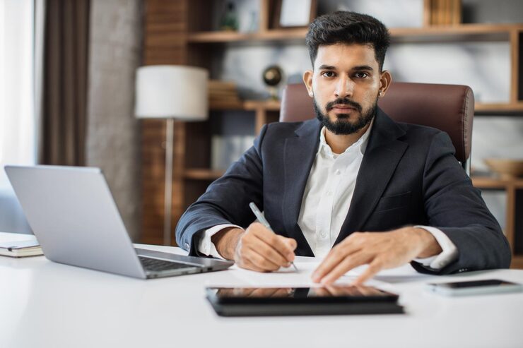 young-bearded-male-accountant-working-from-modern-office-using-laptop_769609-2088